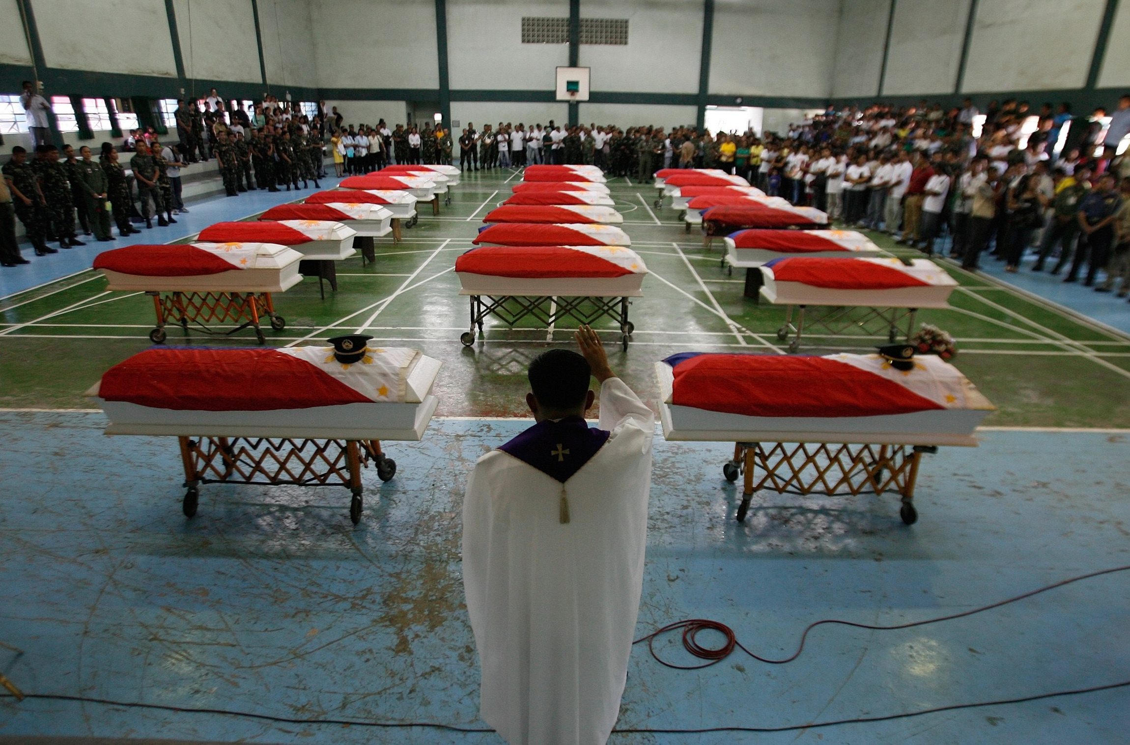 PRIEST LEADS PRAYER SERVICE FOR SOLDIERS KILLED IN BATTLE AGAINST REBELS IN PHILIPPINES