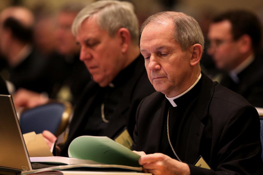 Bishop Thomas J. Paprocki  looks over papers during U.S. Conference of Catholic Bishops' annual fall meeting in Baltimore