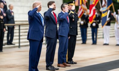 President Donald Trump greets Vice President JD Vance, Defense Secretary Pete Hegseth, Chairman of the Joint Chiefs General Dan Caine, Executive Director of the Office of Army National Military Cemeteries Karen Durham-Aguilera, commanding general of the Joint Task Force-National Capital Region and the US Army Military District of Washington Major General Trevor J. Bredenkamp and LTG Michele Bredenkamp at Arlington National Cemetery, Monday, May 26, 2025, in Arlington, Virginia