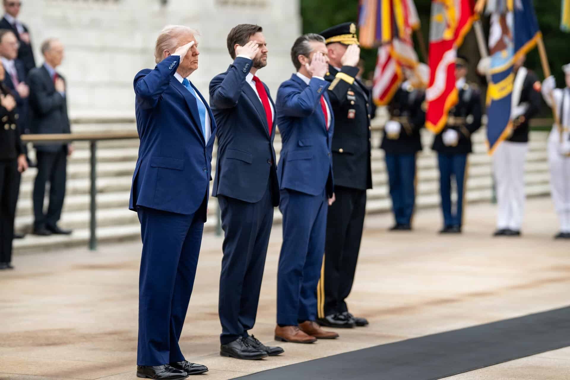 President Donald Trump greets Vice President JD Vance, Defense Secretary Pete Hegseth, Chairman of the Joint Chiefs General Dan Caine, Executive Director of the Office of Army National Military Cemeteries Karen Durham-Aguilera, commanding general of the Joint Task Force-National Capital Region and the US Army Military District of Washington Major General Trevor J. Bredenkamp and LTG Michele Bredenkamp at Arlington National Cemetery, Monday, May 26, 2025, in Arlington, Virginia